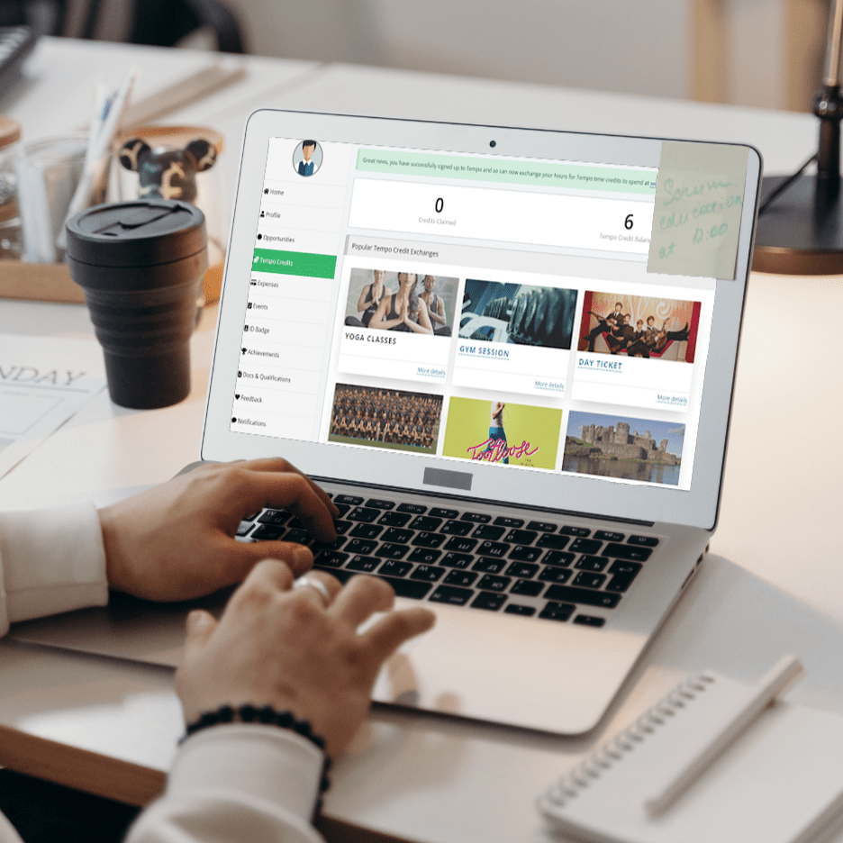 Laptop showing Tempo Time Credits page within the TeamKinetic system